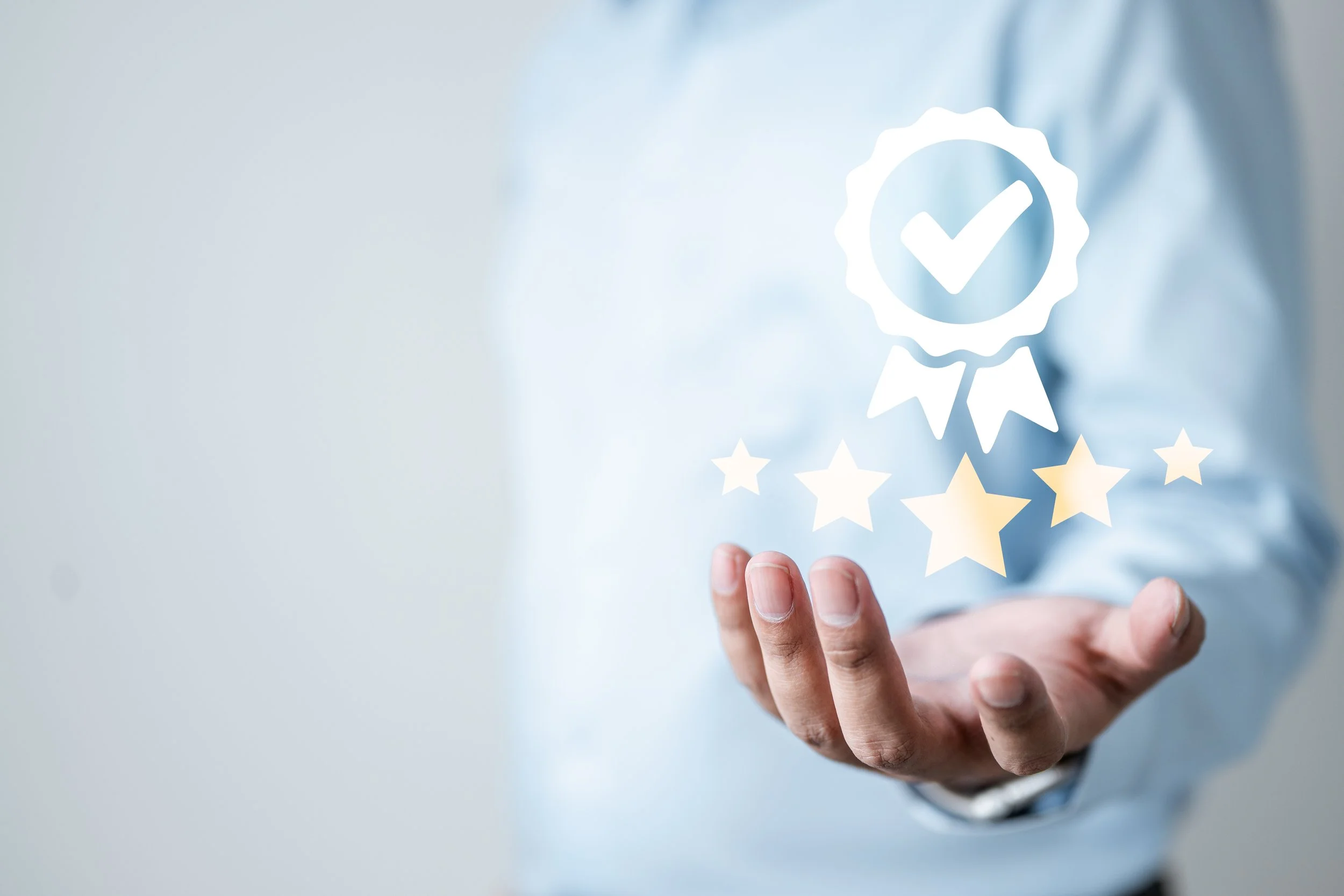 A person in a light blue shirt holding out their hand with a digital overlay of a badge with a checkmark, stars, and ribbons representing quality or approval.
