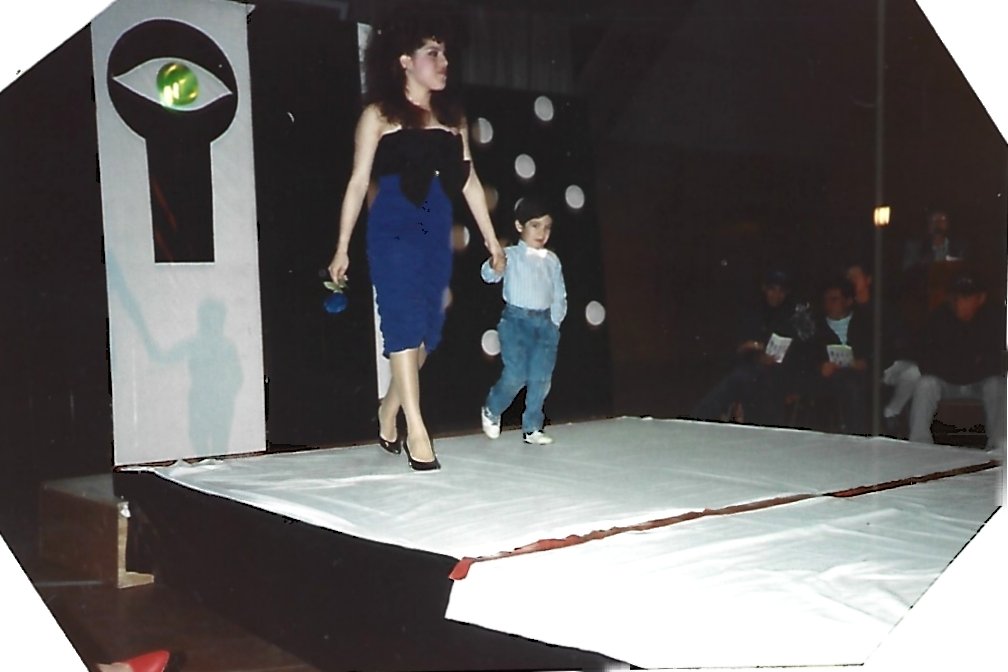 Childhood photo of Rene Campos walking on stage during a formal event, reflecting early public presence and confidence.