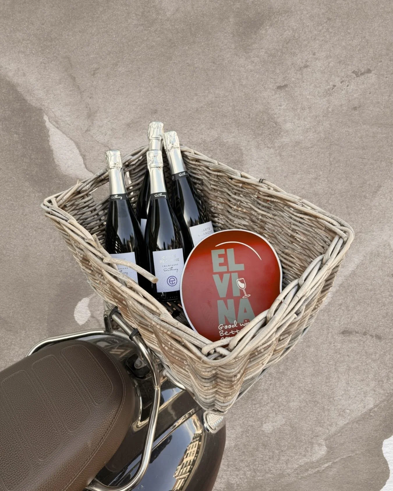 Champagne in a wicker basket on an Elvina scooter, ready for delivery