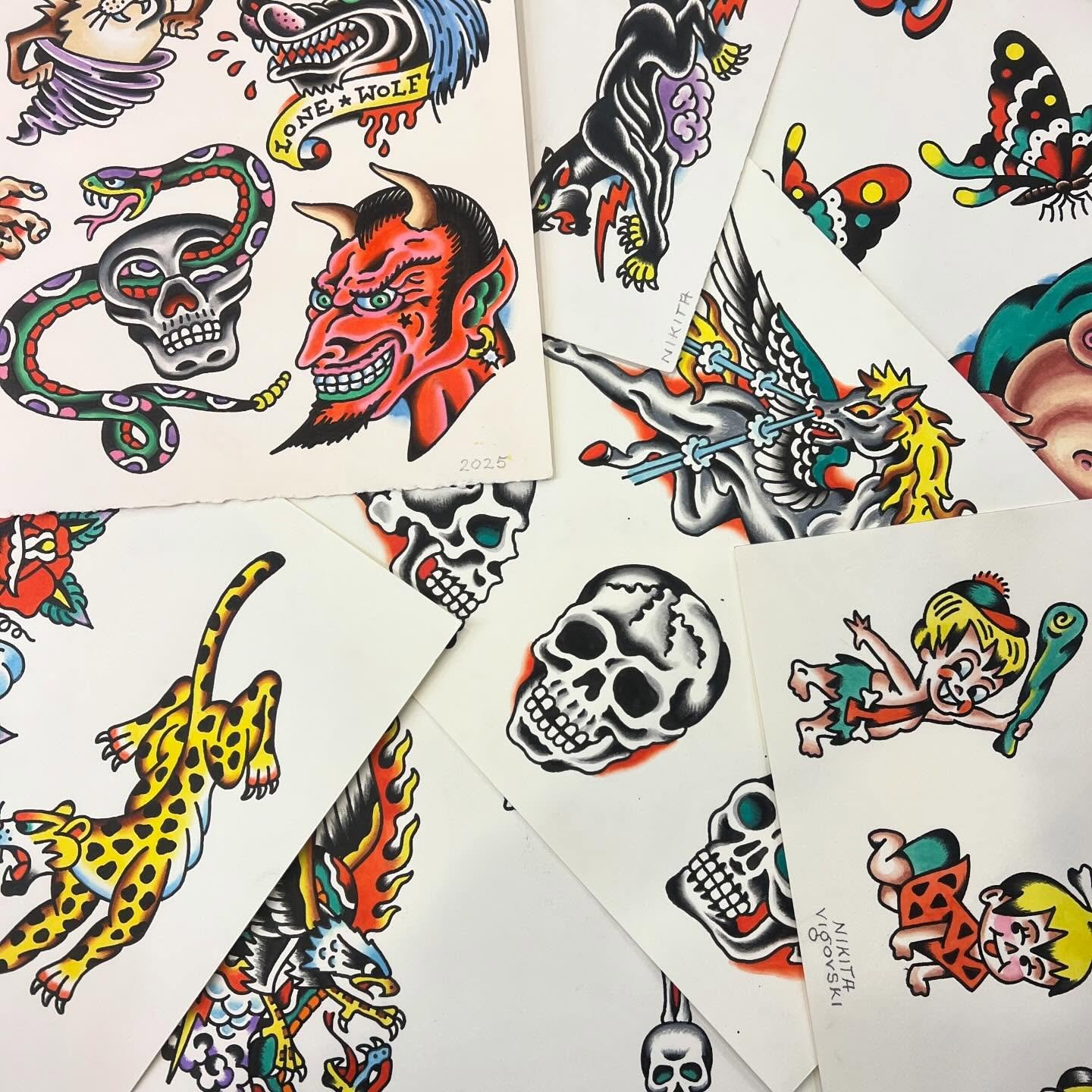 Collection of traditional American flash-style tattoo designs including skulls, a devil head, a snake, a tiger, a winged creature, butterflies, and a cartoon girl with a bat.