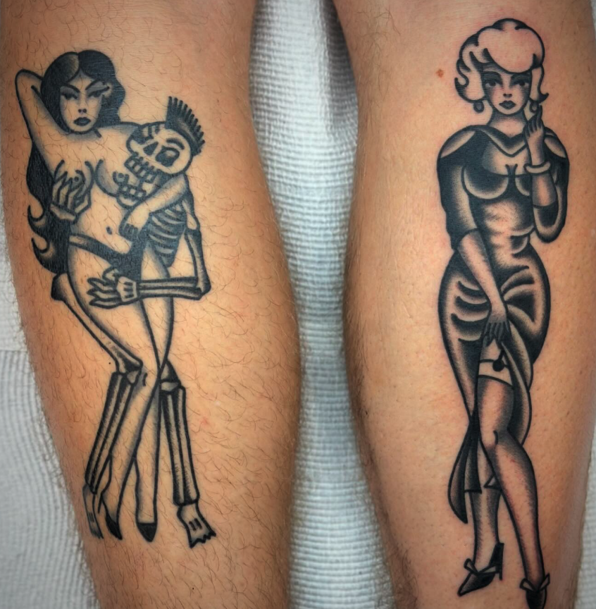 Two black and gray tattoos of stylized women on arms. The left tattoo shows a woman sitting on a skeleton, both with dark hair and vintage clothing. The right tattoo depicts a woman with short curly hair, wearing a dress with a slit, and standing wit