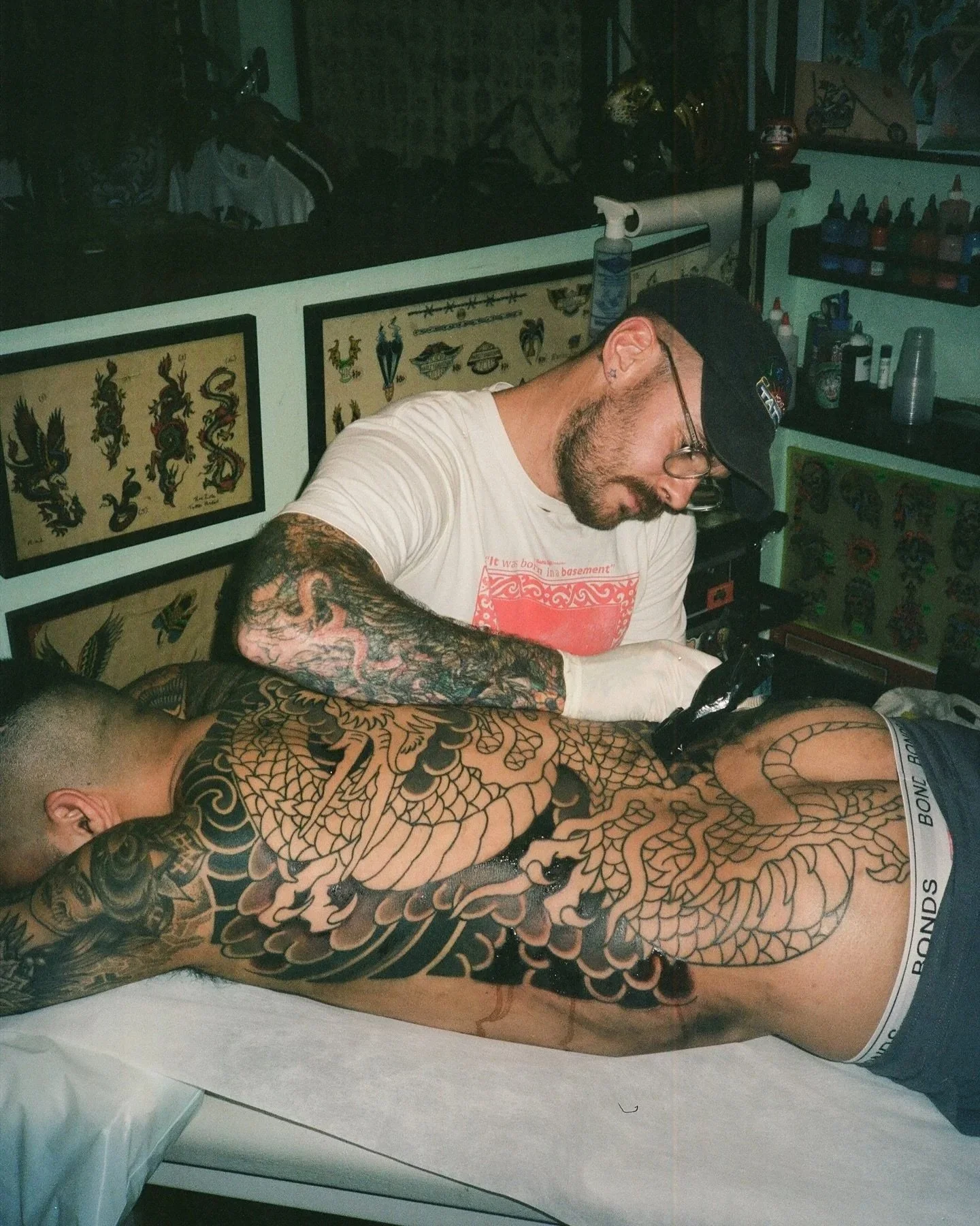 Benjamin Hastings tattooing client at Tattoo Rosie's