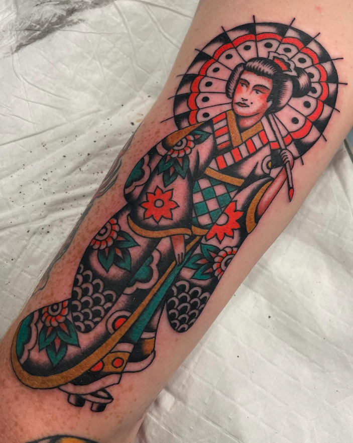 Tattoo of a traditional Japanese woman with a parasol, colorful kimono, and floral design on leg.