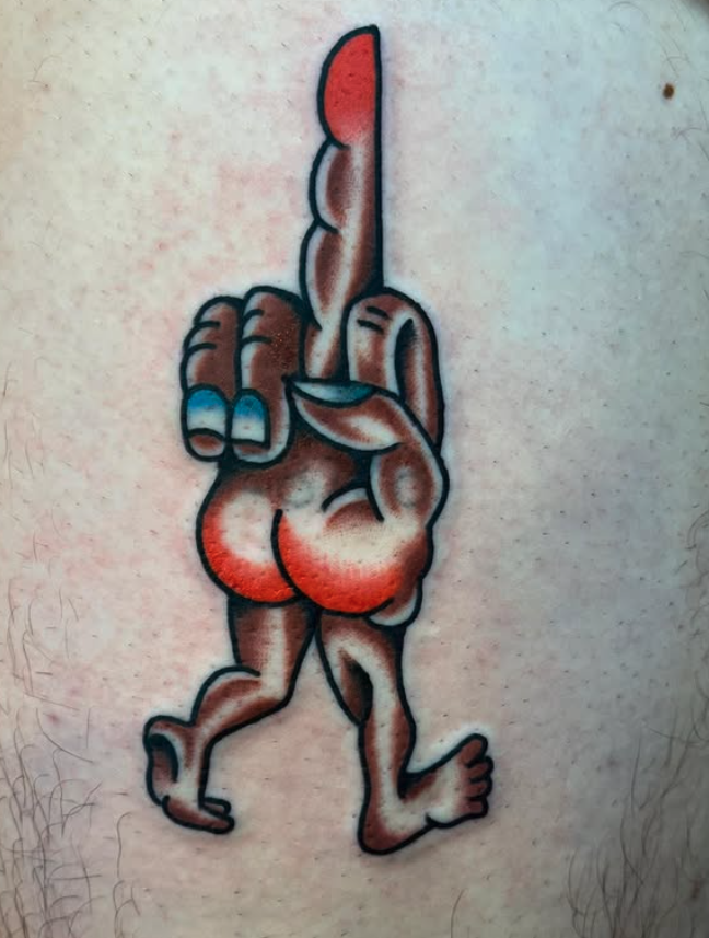 A tattoo of a cartoonish pregnant woman with a large belly and long hair, holding her middle finger up.