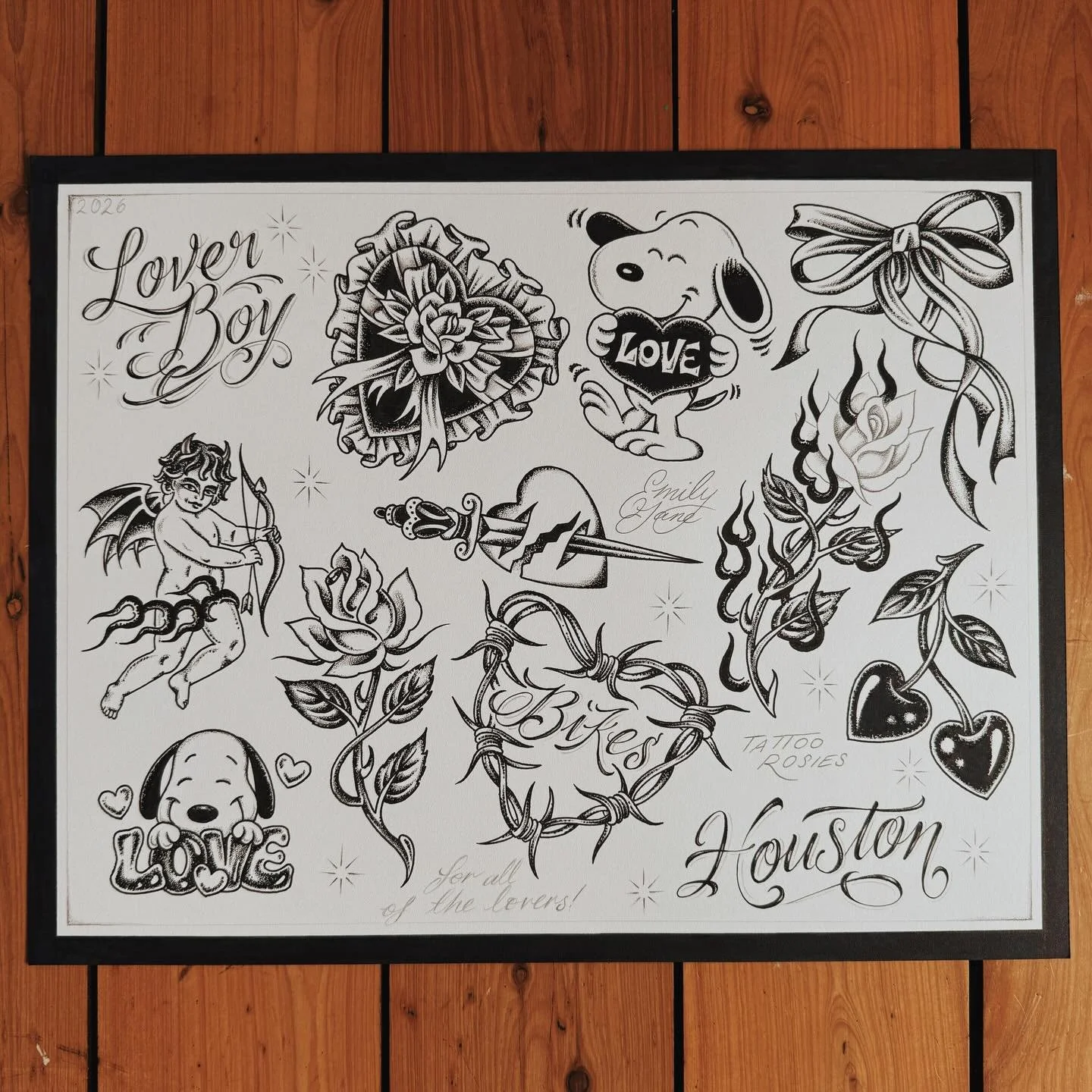 A black and white sheet of tattoo flash art with various love and romantic-themed images, including a heart with a rose, Snoopy holding a heart, the words 'Love Boy' and 'Love,' a Cupid with a bow and arrow, roses, cherries, a dog with the word 'Love