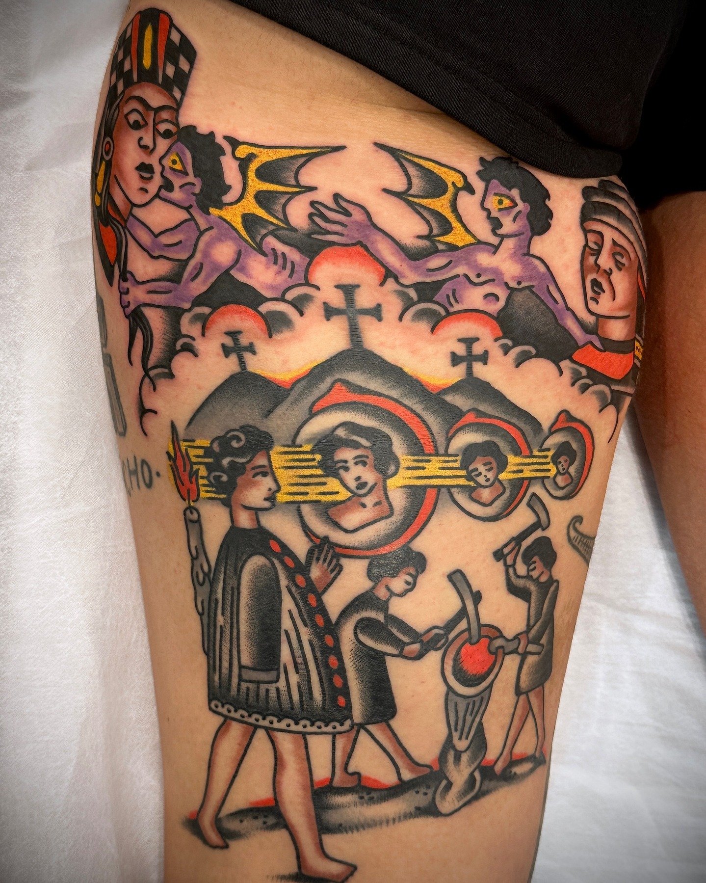 Tattoo featuring religious and mythological imagery with saints, angels, and other figures in a traditional tattoo style.
