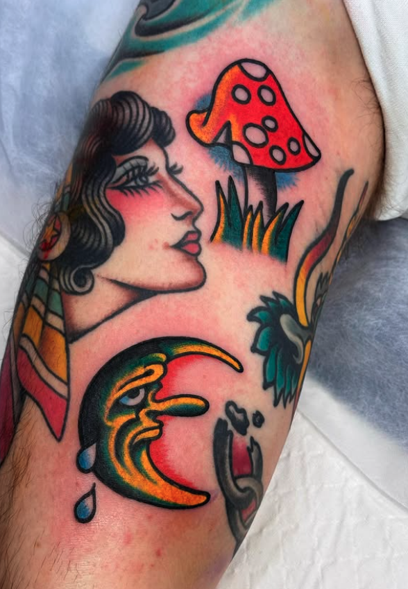 Tattoo of a woman's profile, a red mushroom with white spots, and a colorful crescent moon with a face and a tear.