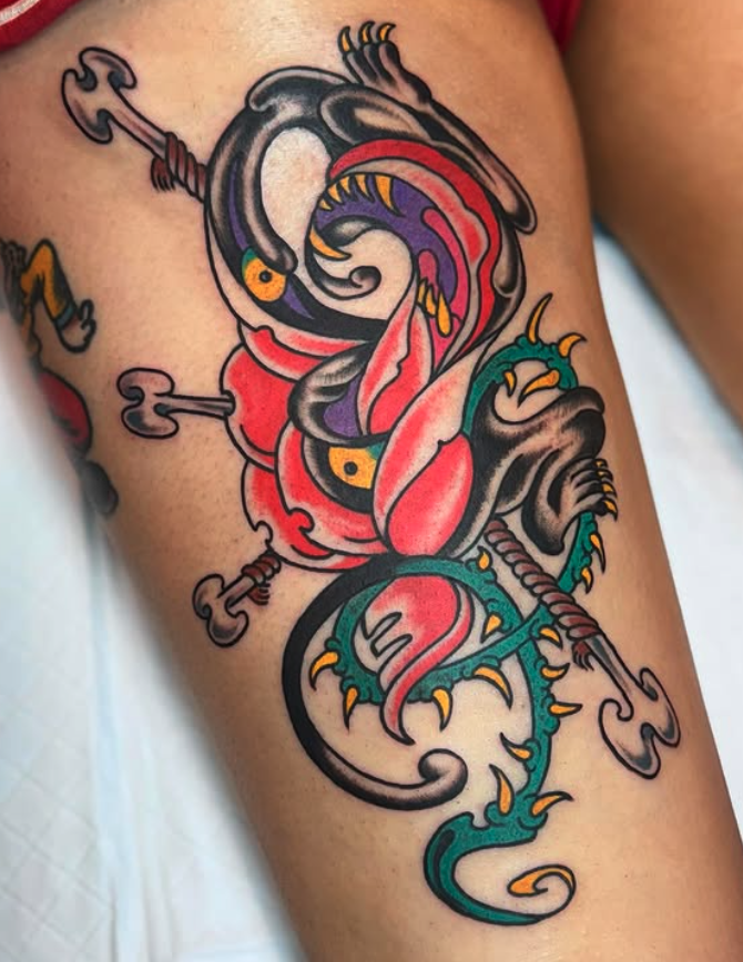 Colorful tattoo of a phoenix with flames on skin.