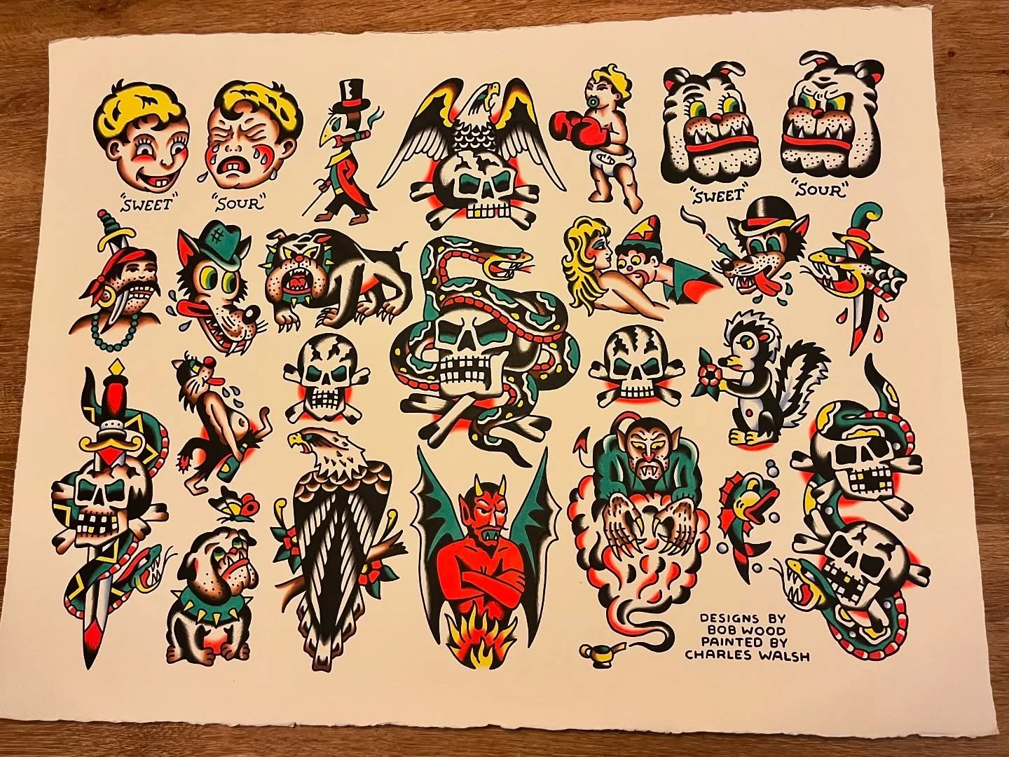 Collection of traditional tattoo flash designs with various skulls, animals, and characters in colorful, vintage tattoo style.