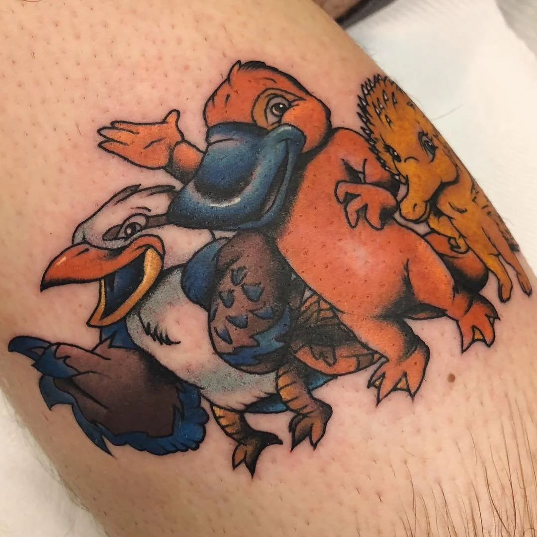 Colorful tattoo of cartoon characters Duck, Goose, and Chip from Disney's Jungle Cruise, with Duck at the center, Goose on the left, and Chip on the right.