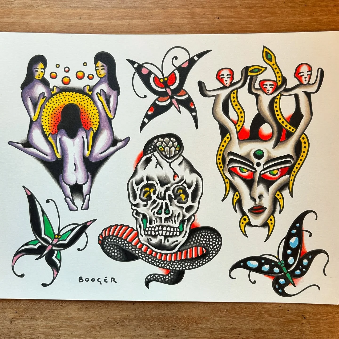 Tattoo-style illustration featuring purple menstruating women, a butterfly, four snake-headed figures emerging from a face, a skull with a snake coiled around it, and two additional butterflies, all with bold black outlines and vibrant colors.