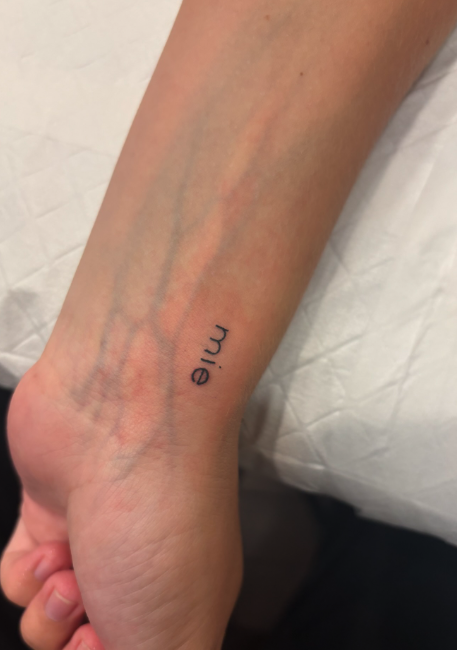 Tattoo reading 'mie' on ankle
