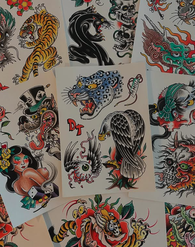 Collection of traditional tattoo-style flash art featuring various designs including a tiger, a black panther, a dragon, skulls, an eagle, a woman with flowers, and a snake.