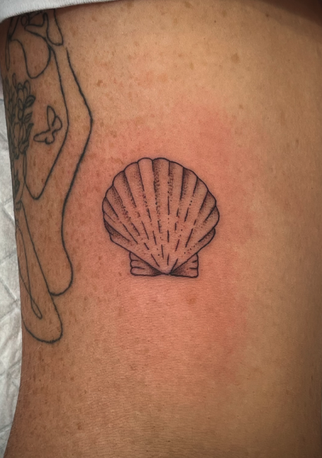Tattoo of a seashell on skin