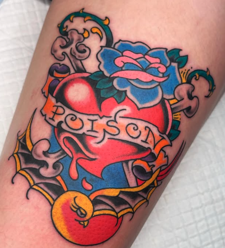 Tattoo of a broken heart with a rose on top, wrapped with a banner that reads 'Poison', surrounded by clouds, spider webs, and a yellow circus ball.