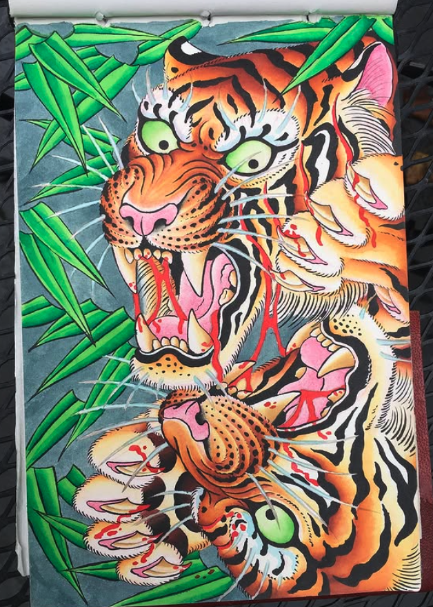 A colorful illustration of two roaring tigers with green eyes, surrounded by green bamboo leaves.