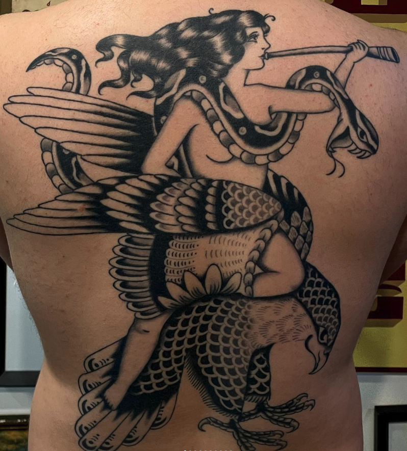 Tattoo of a woman with wings and a snake wrapped around her body, holding a telescope to her eye.