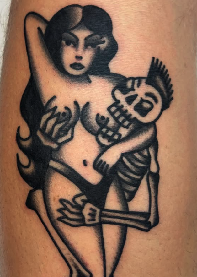 Tattoo of a vintage-style woman with dark hair and makeup, holding a skeleton with a striped shirt, both depicted in black ink.