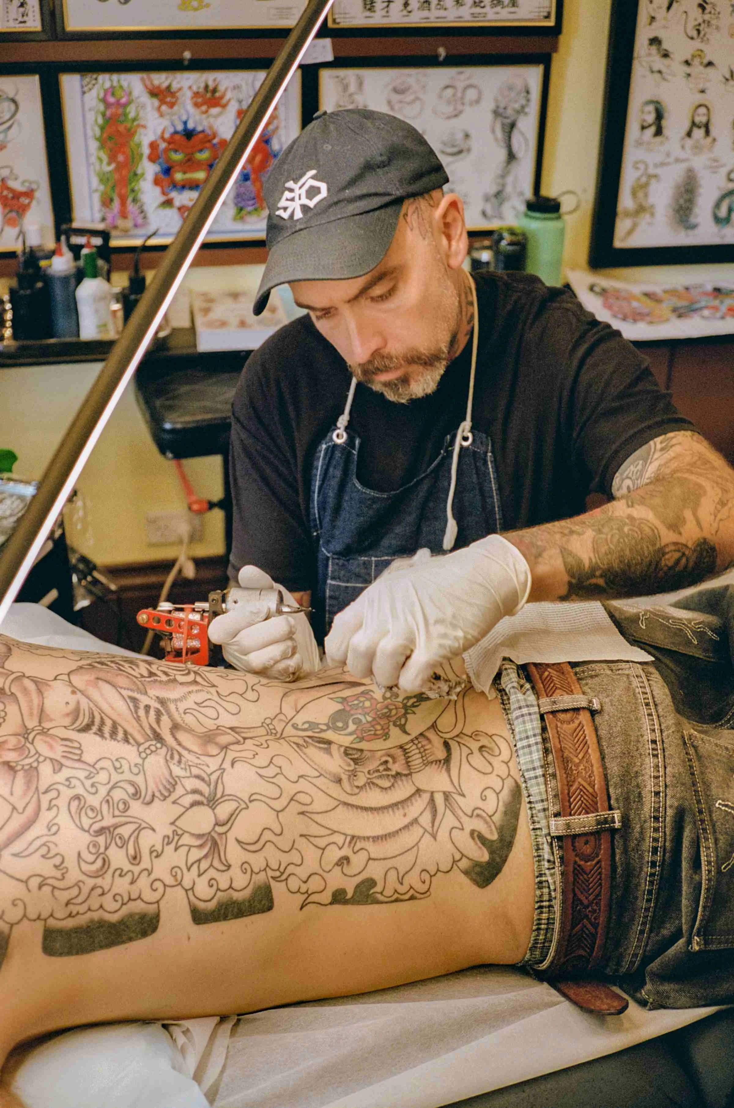 Zak Penny tattooing client at Tattoo Rosie's