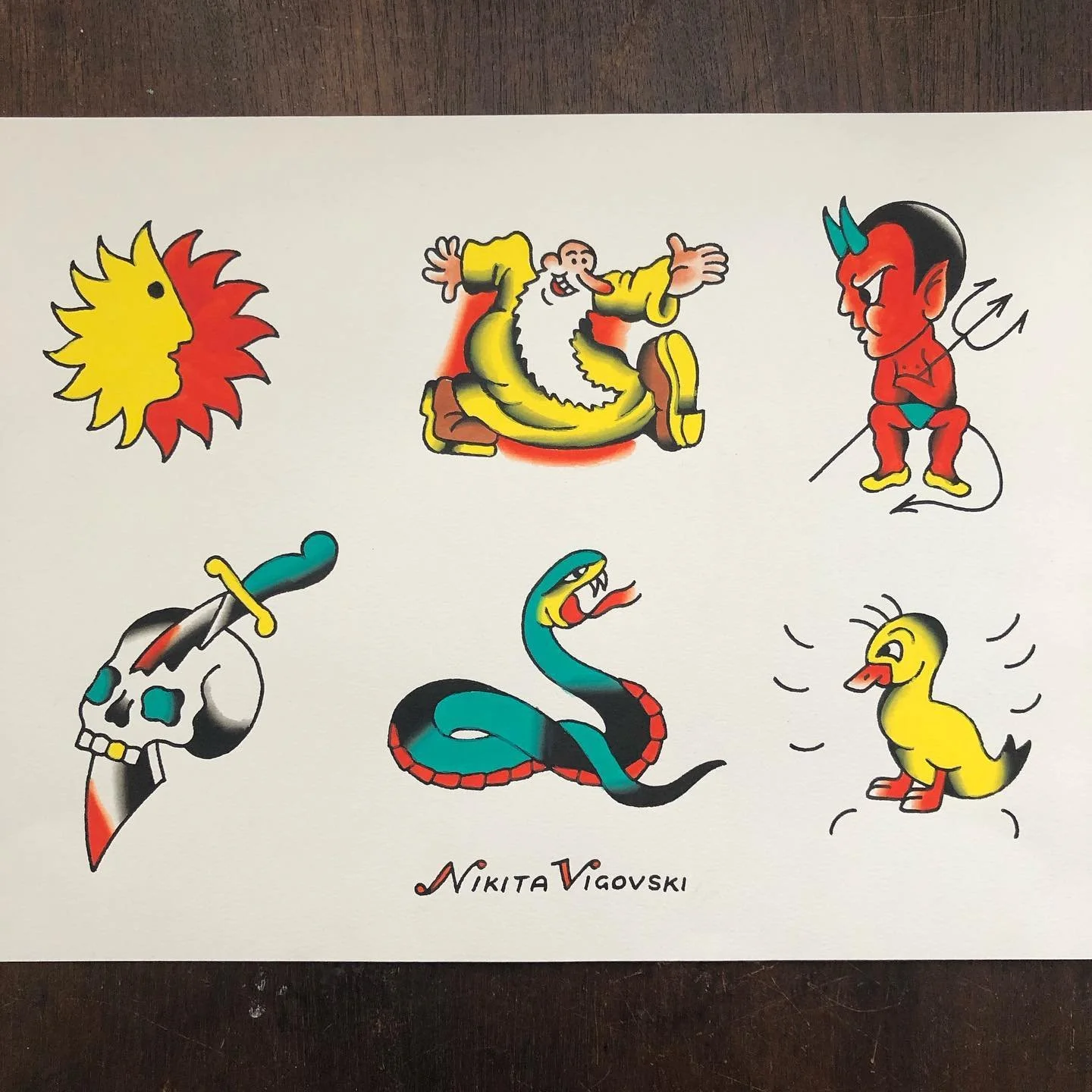 Collection of six colorful tattoo-style illustrations: a sun with a face, a bearded wizard in yellow robe, a devil with red skin and horns, a skull with a dagger, a snake with an open mouth, and a cute yellow duckling. Signed by Nikita Viguovski.