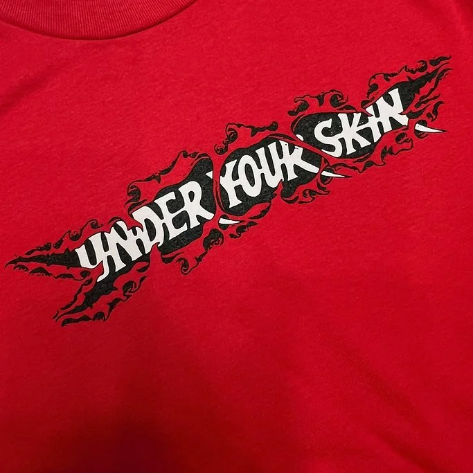 UnderYourSkinTeeLogo.jpg