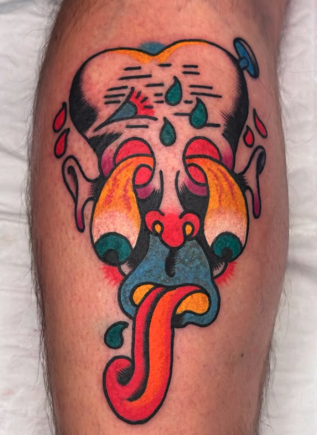 Colorful tattoo of a stylized skull with a long tongue, teardrops, and dripping elements, in traditional tattoo style.