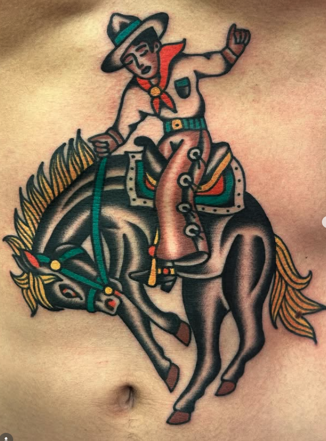 Tattoo of a cartoon cowboy riding a bucking horse on a person's torso.