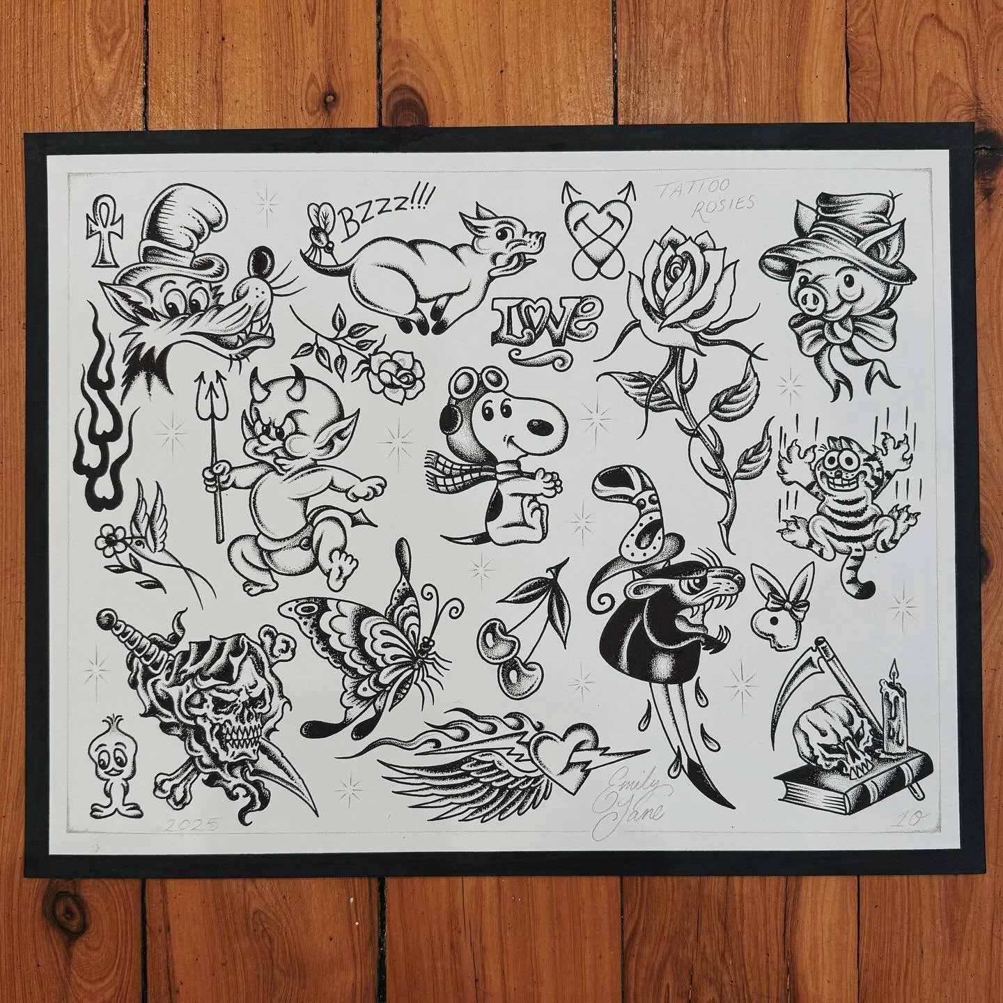 A black and white sheet of tattoo flash art featuring various tattoo designs such as a dragon, devil, butterfly, rose, skull, and other traditional tattoo motifs.