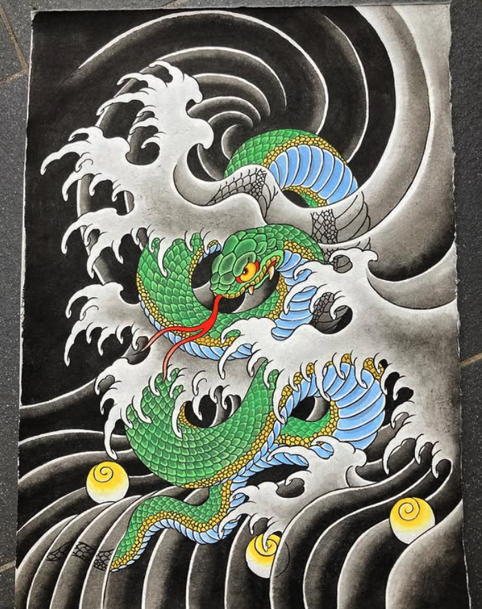 A colorful traditional dragon tattoo design featuring a green and blue dragon with yellow accents, surrounded by black and white waves with two yellow swirls in the water.