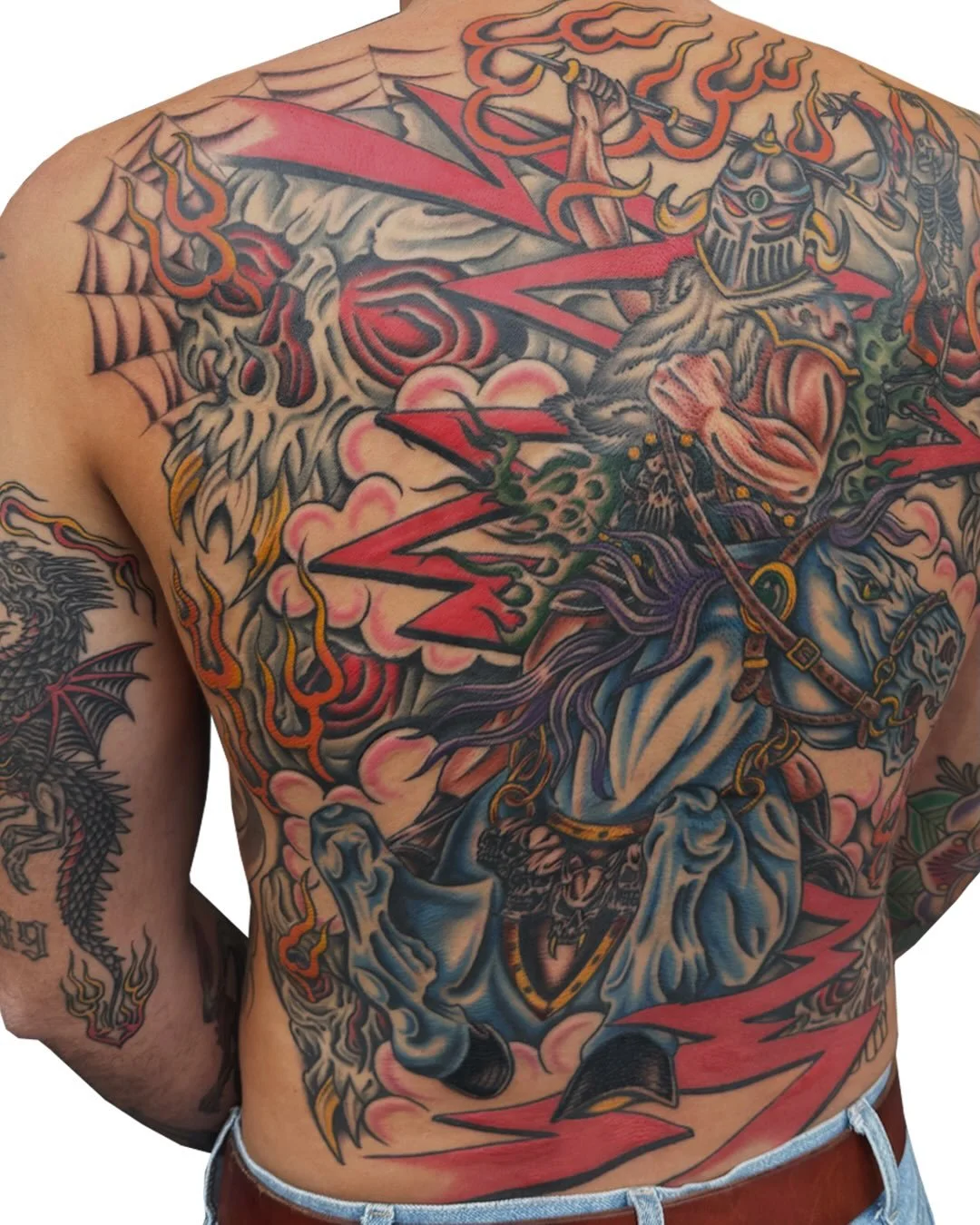 A colorful chest tattoo featuring a warrior riding a horse, wielding a sword, with flames, clouds, and other mythic elements surrounding it.