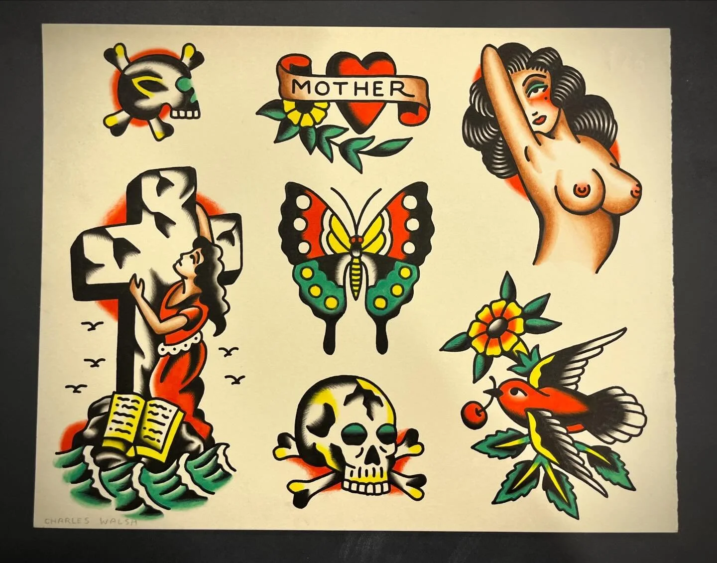 Tattoo flash sheet with traditional style images including a skull, butterfly, woman in a vintage pin-up pose, cross with a woman clinging to it, a flower with bird, a heart with 'Mother' banner, a skull with bones, and a stylized round face with eye