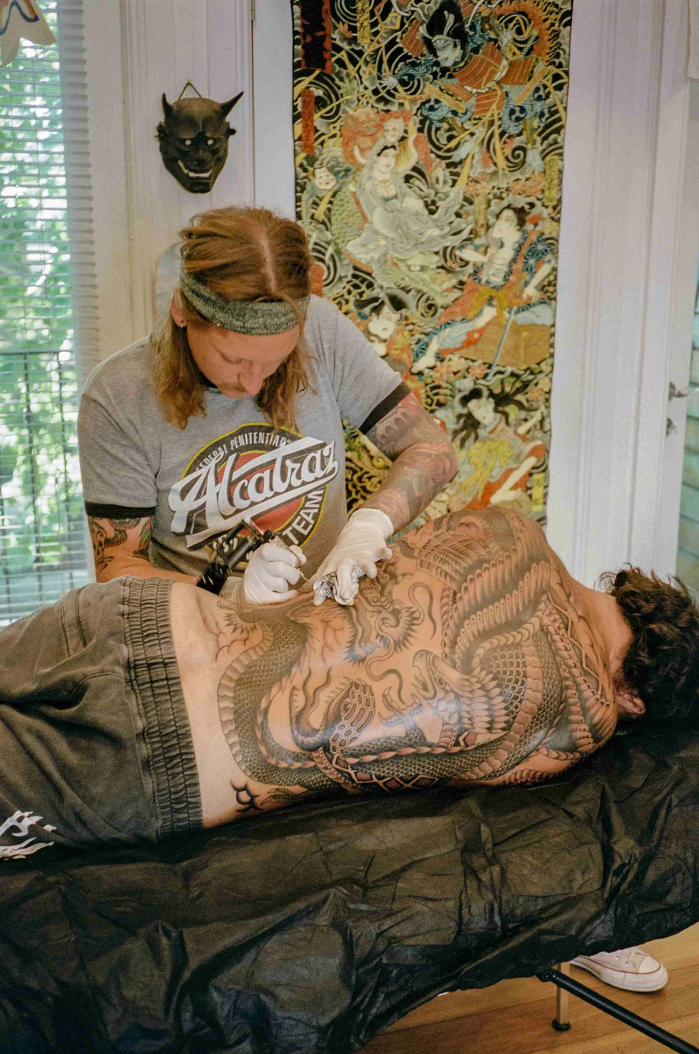 Johann Ingemar tattooing client at Tattoo Rosie's