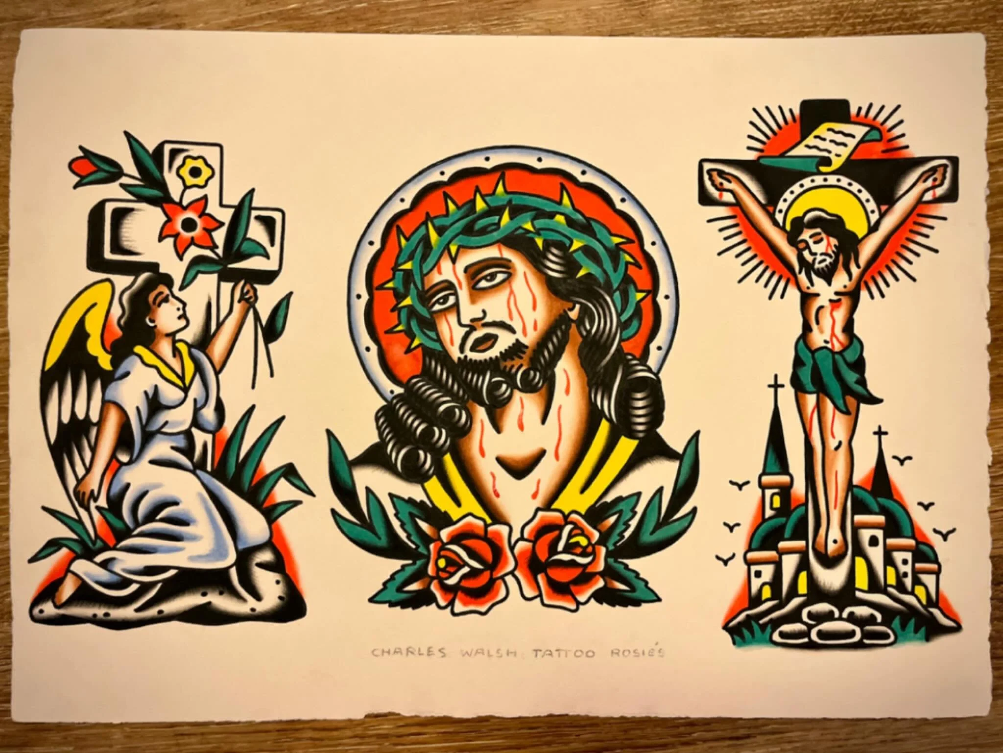Traditional style tattoo artwork featuring Jesus Christ with a crown of thorns in the center, an angel with a cross on the left, and Jesus on the cross on the right.