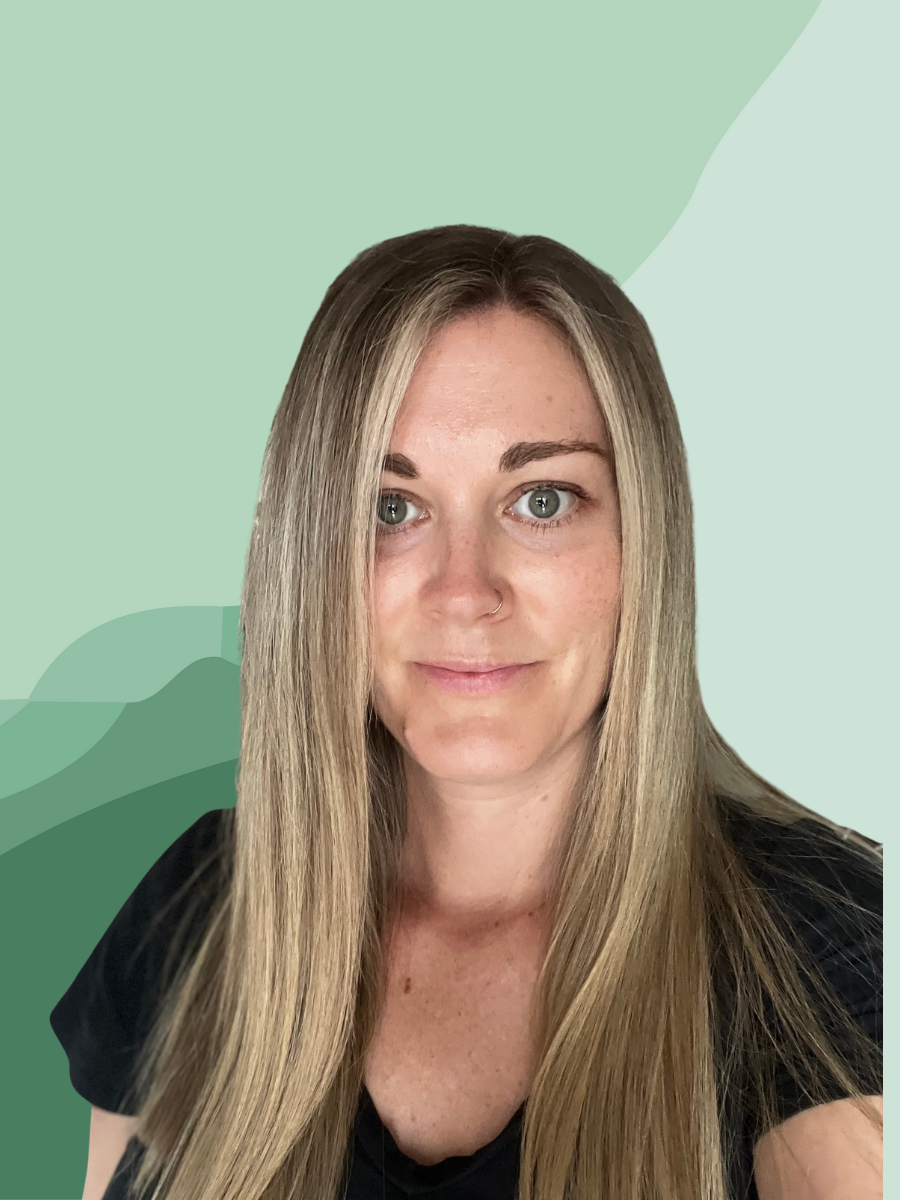 A woman with long blonde hair, wearing a black top, smiling at the camera against a green abstract background.