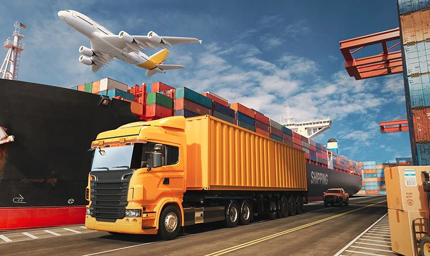 A shipping port with a large cargo ship, stacked containers, a yellow freight truck, and an airplane flying overhead.