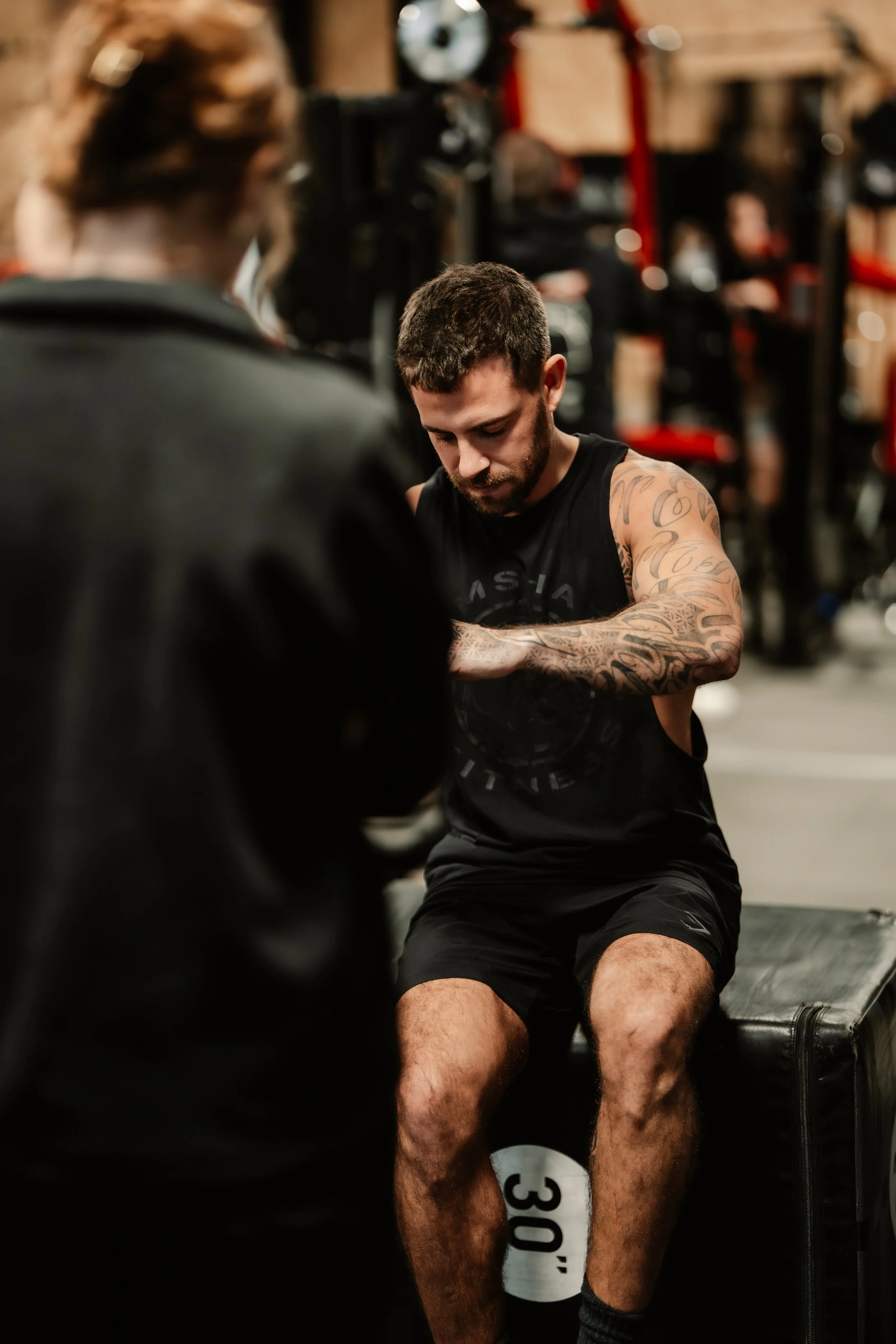 Man receiving one-to-one gym-based physiotherapy, using the gym facilities and equipment.