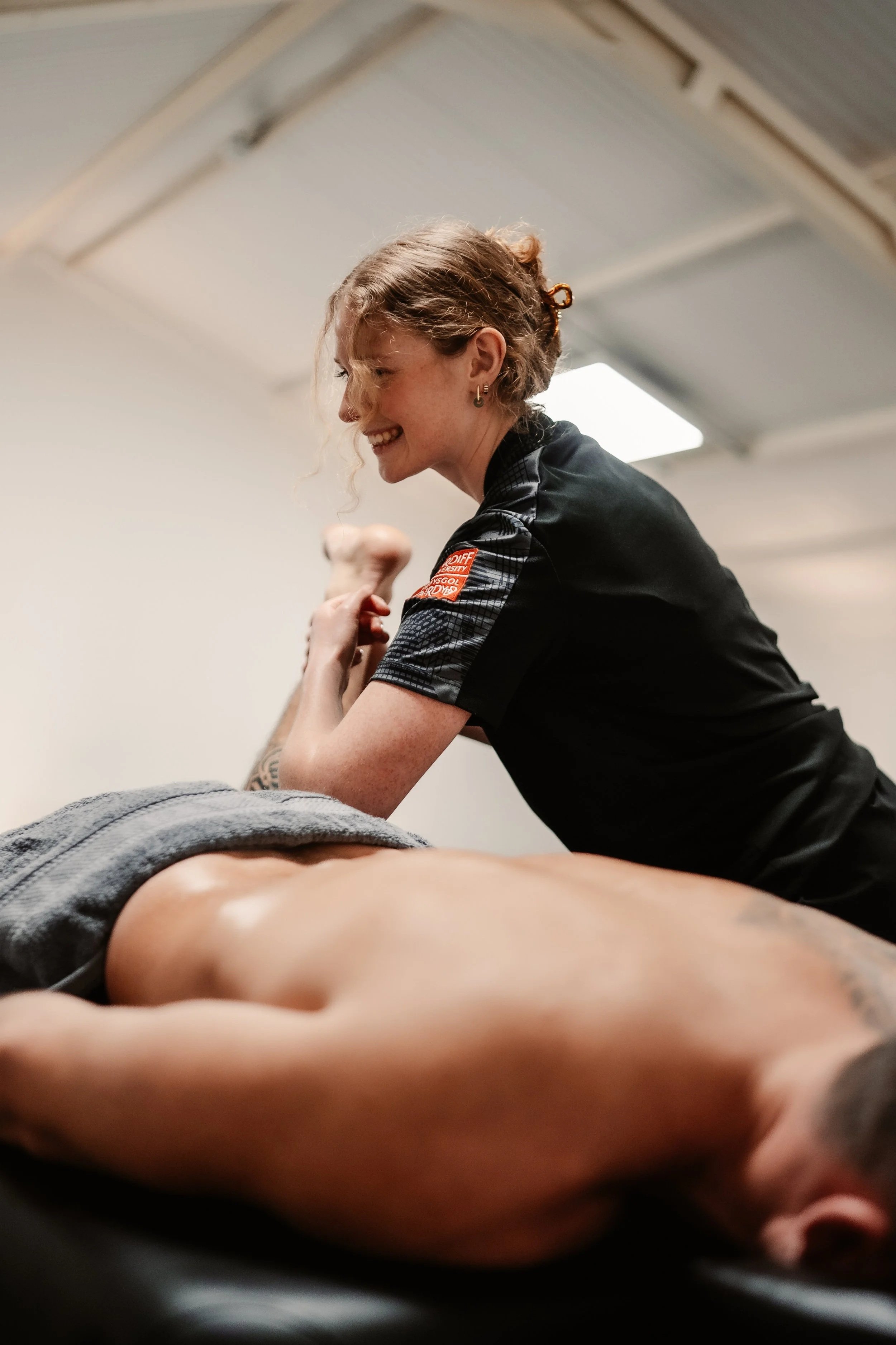 A massage therapist using sports massage techniques to improve hip mobility and reduce soreness