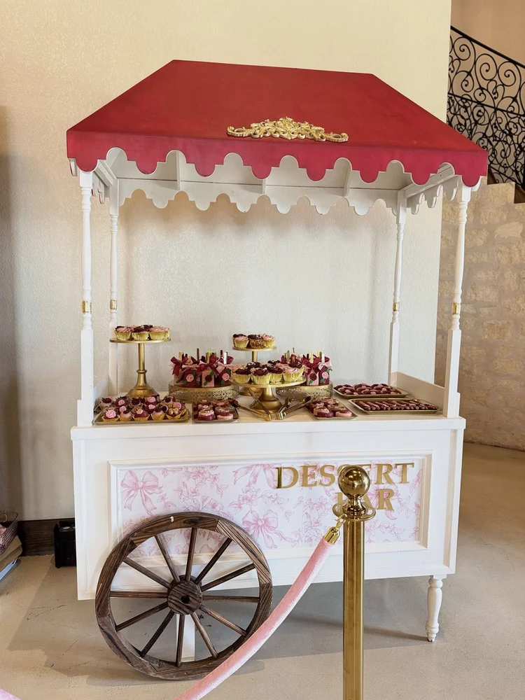 White and red dessert bar candy cart rental with gold stands and desserts at a quinceañera