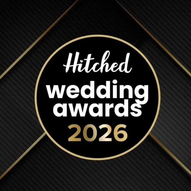 Black background with gold and white text reading "Hitched wedding awards 2026" in a circular design.