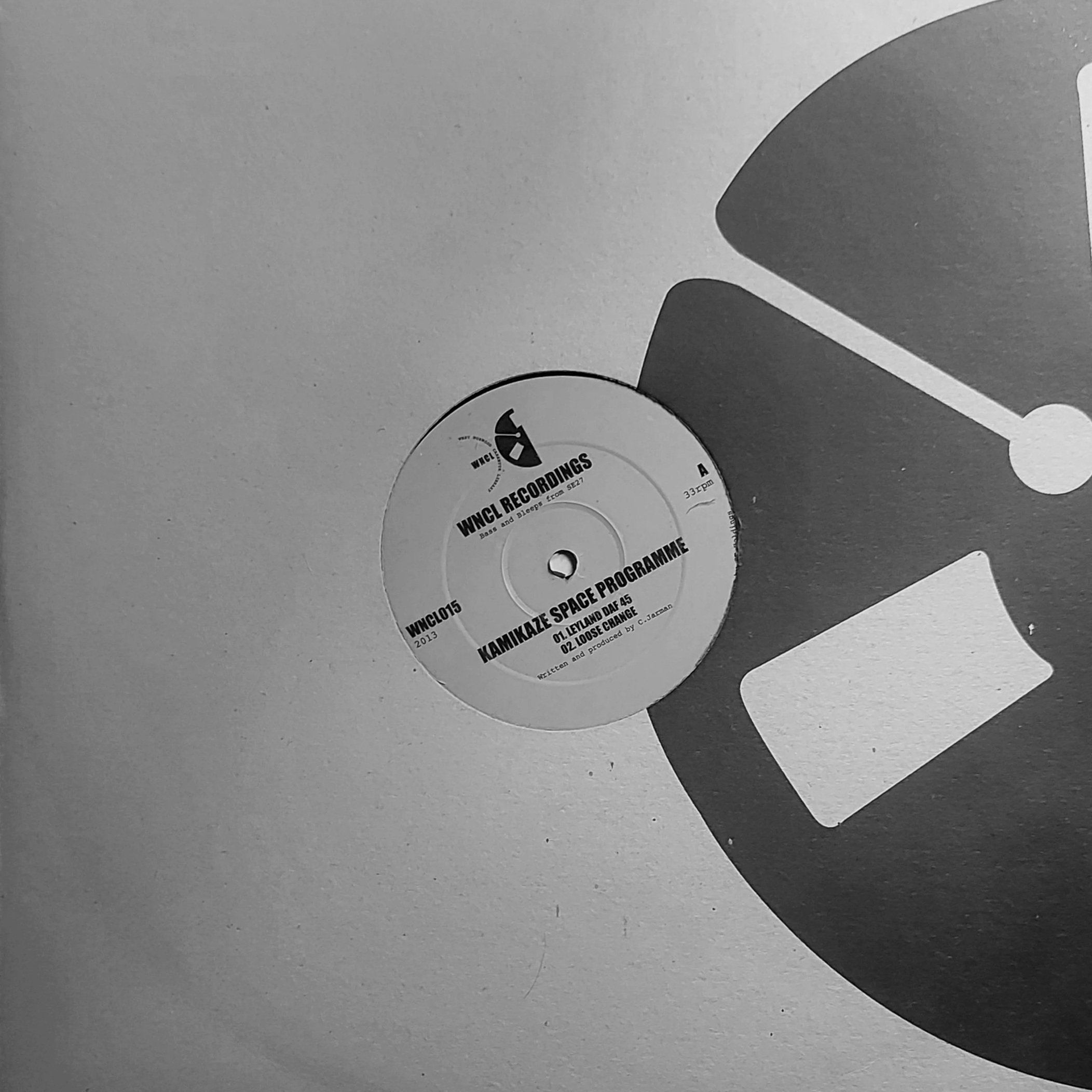 Close-up of a vinyl record on a turntable with partially visible text that reads 'WNCL RECORDINGS'.