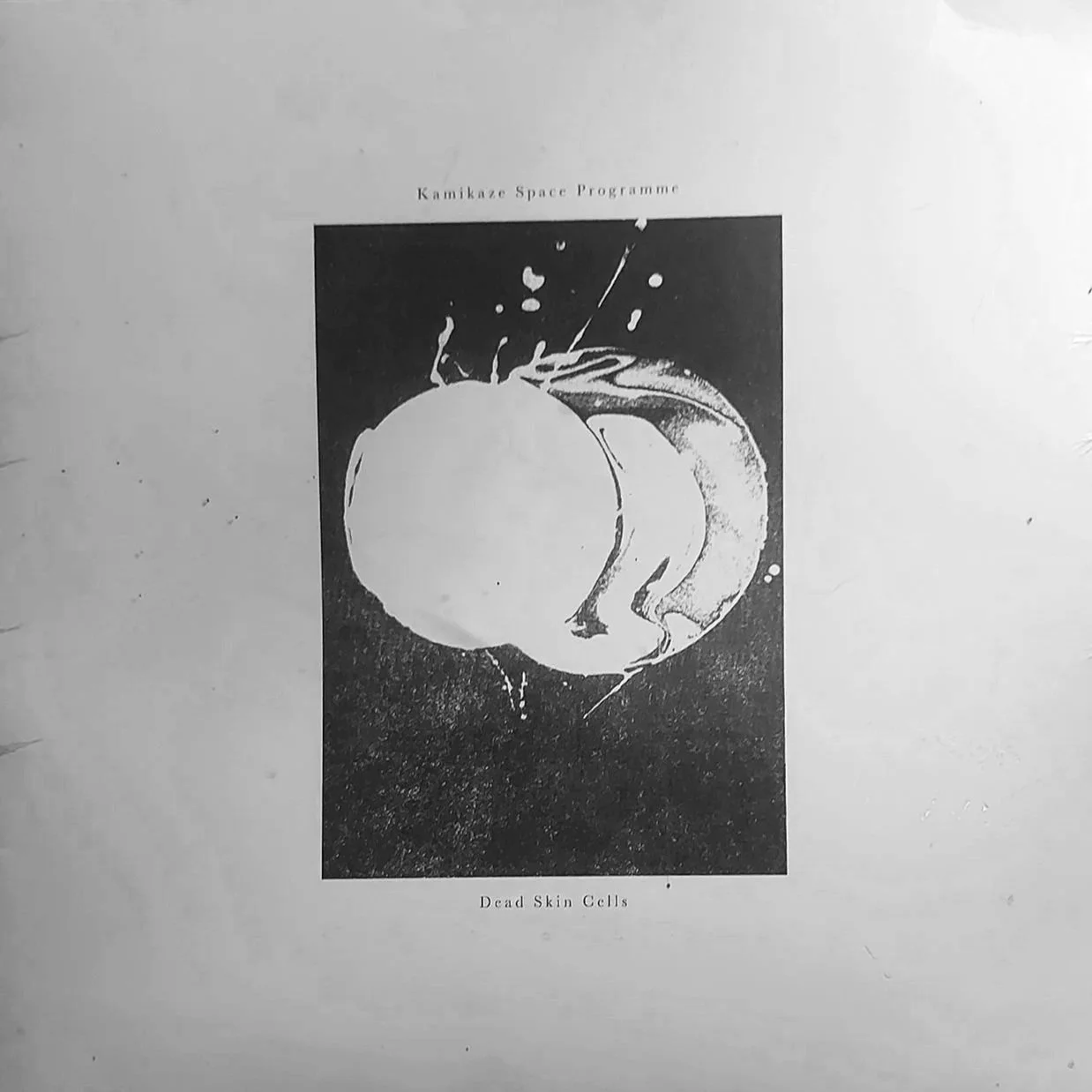 Black and white cover page of Kamikaze Space Programme with an image of a planet and space imagery, captioned 'Dead Skin Cells'.