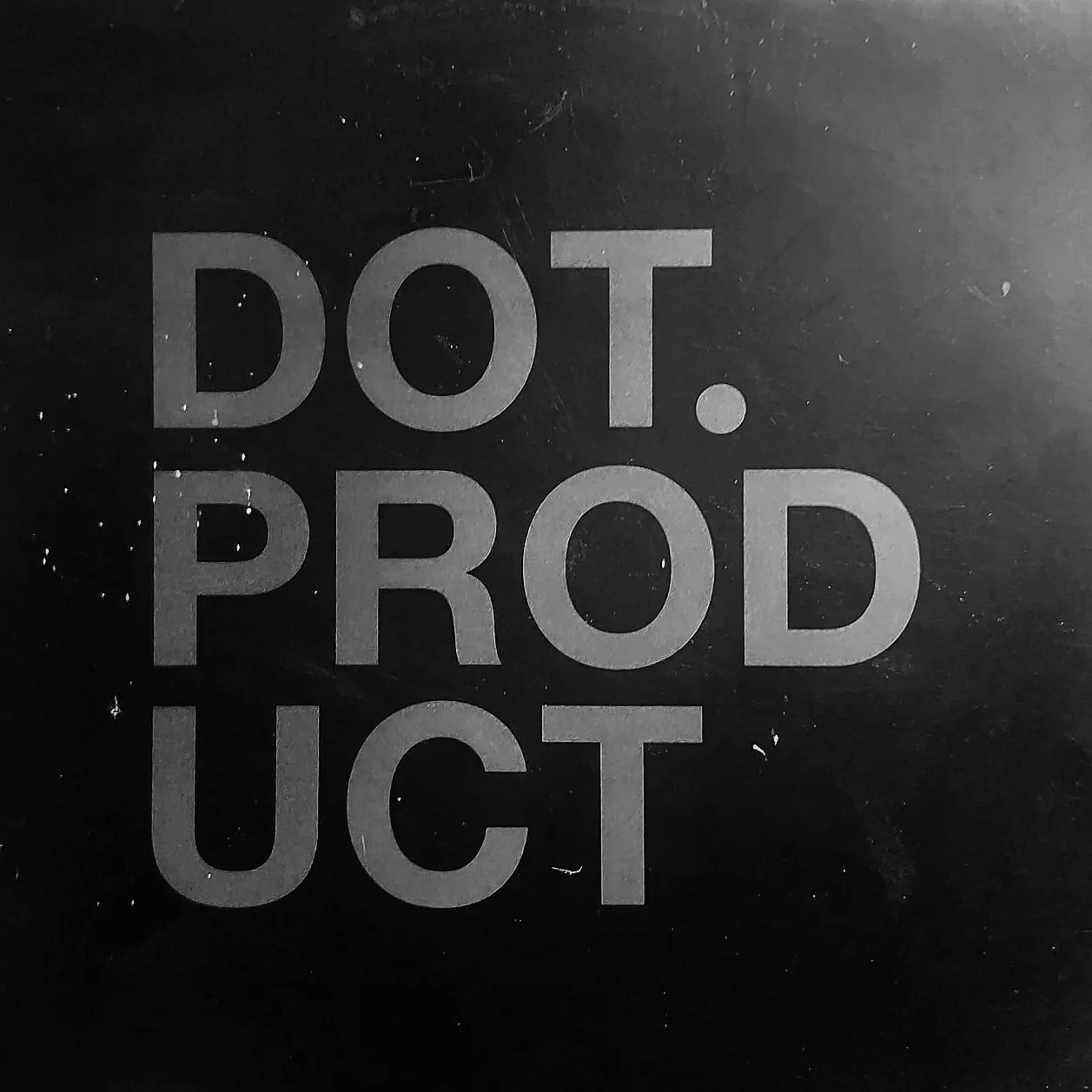 Black surface with white text reading "DOT. PROD. UCT."