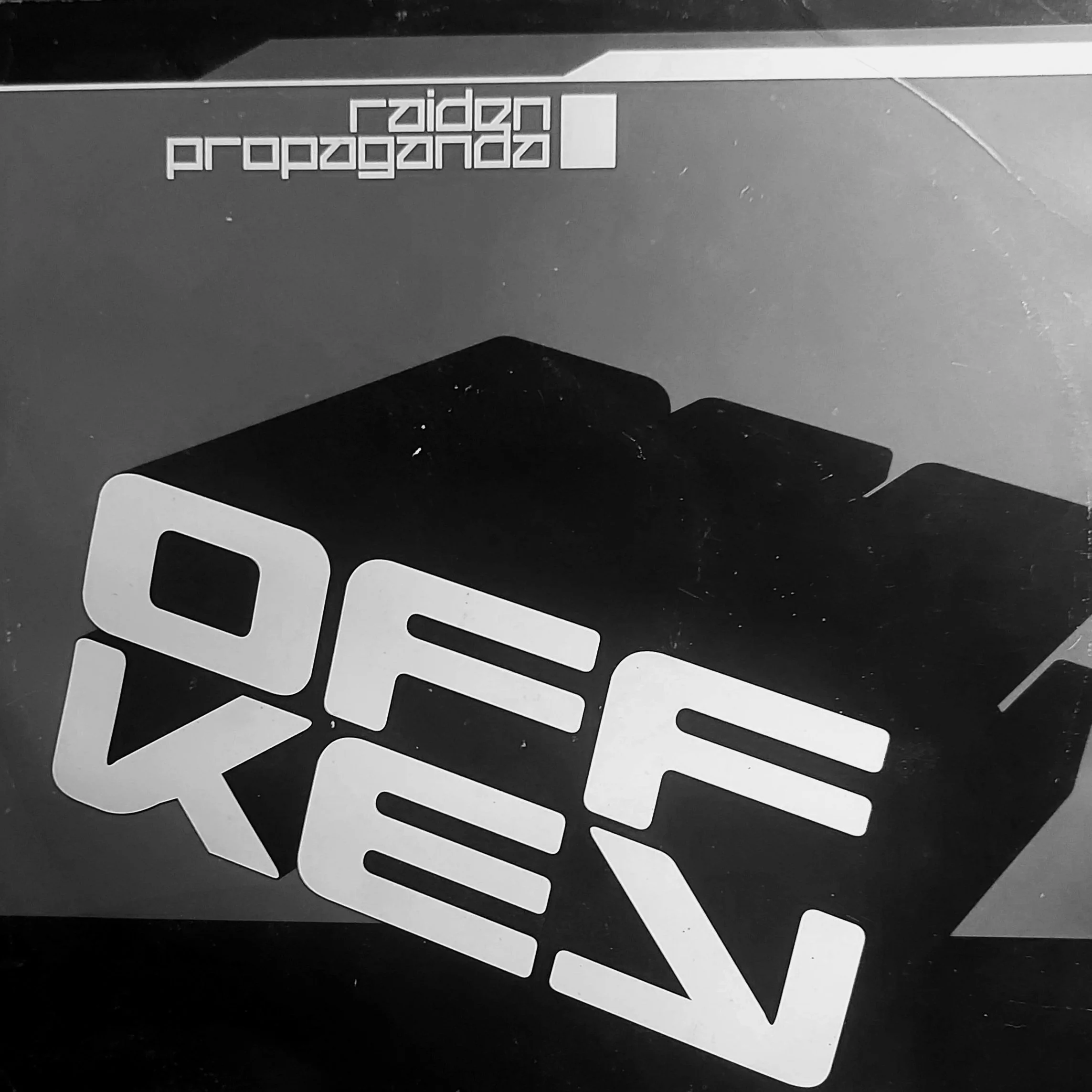 Black and white image of a stacked pile of cut-out letter shapes with rounded edges, arranged randomly with some overlaps.