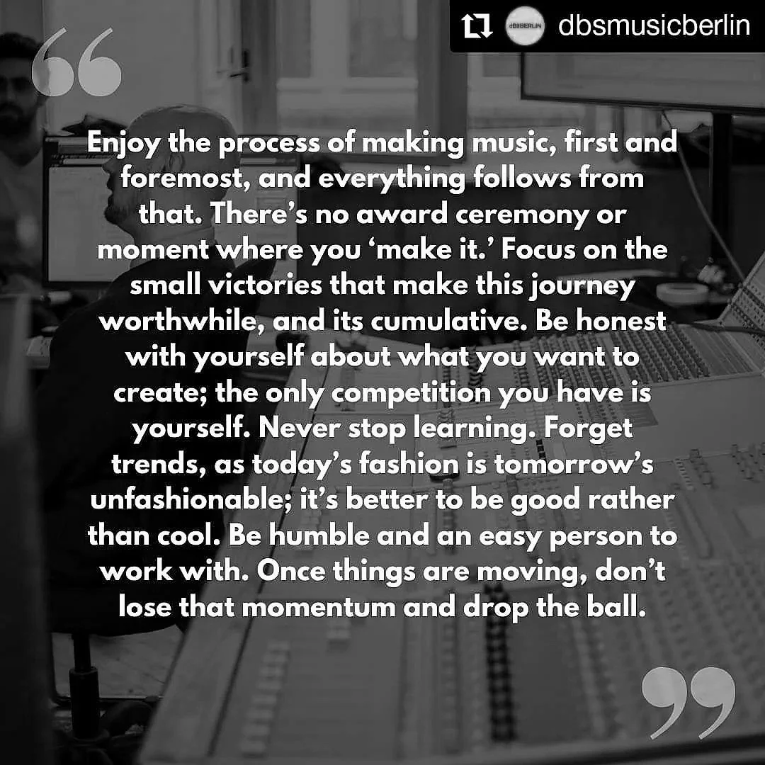 A motivational quote about music creation and personal growth overlaid on a black-and-white photo of a person working in a music studio with equipment and a monitor in the background.