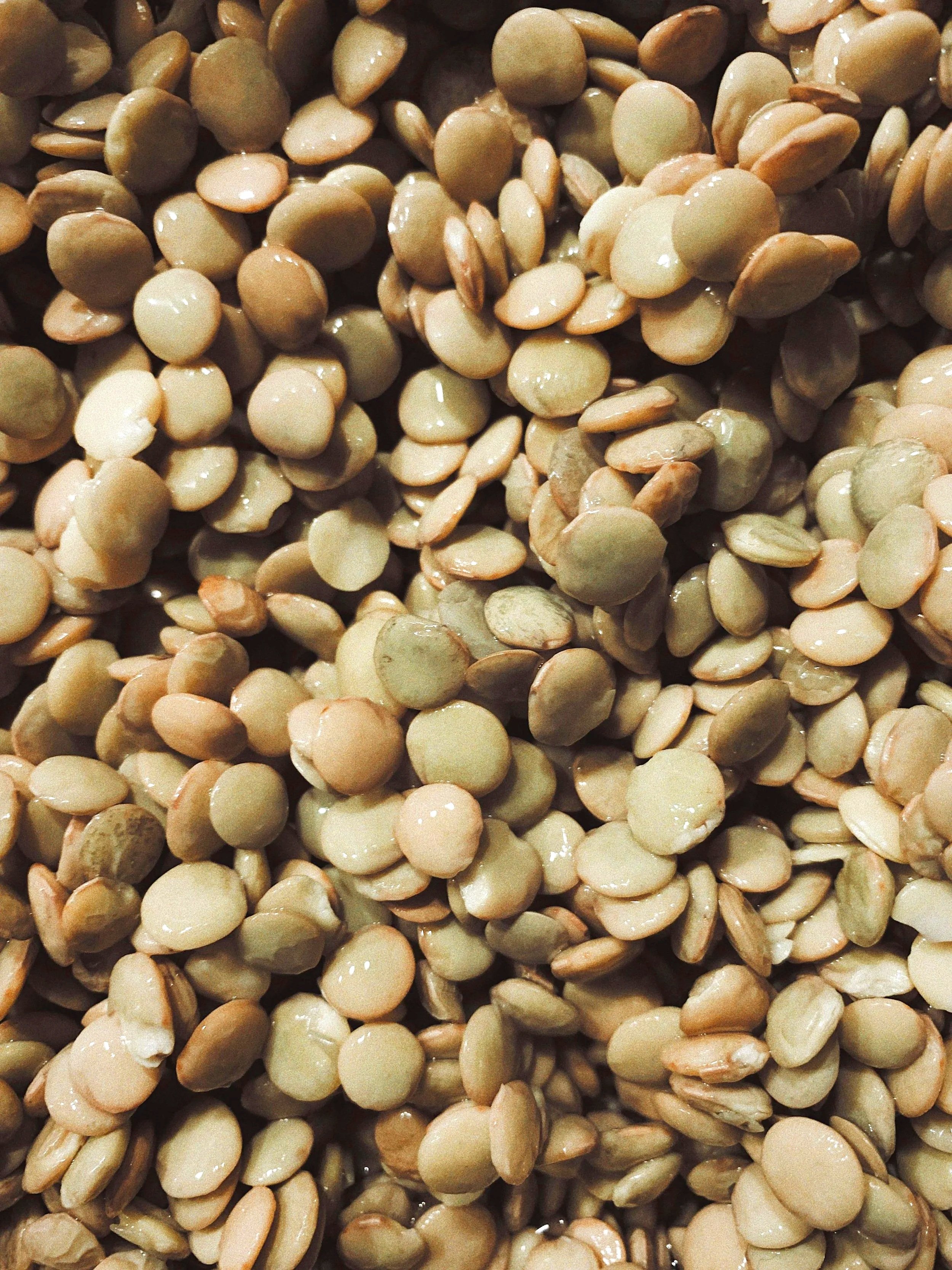 Close-up of a large pile of raw, shelled lentils.