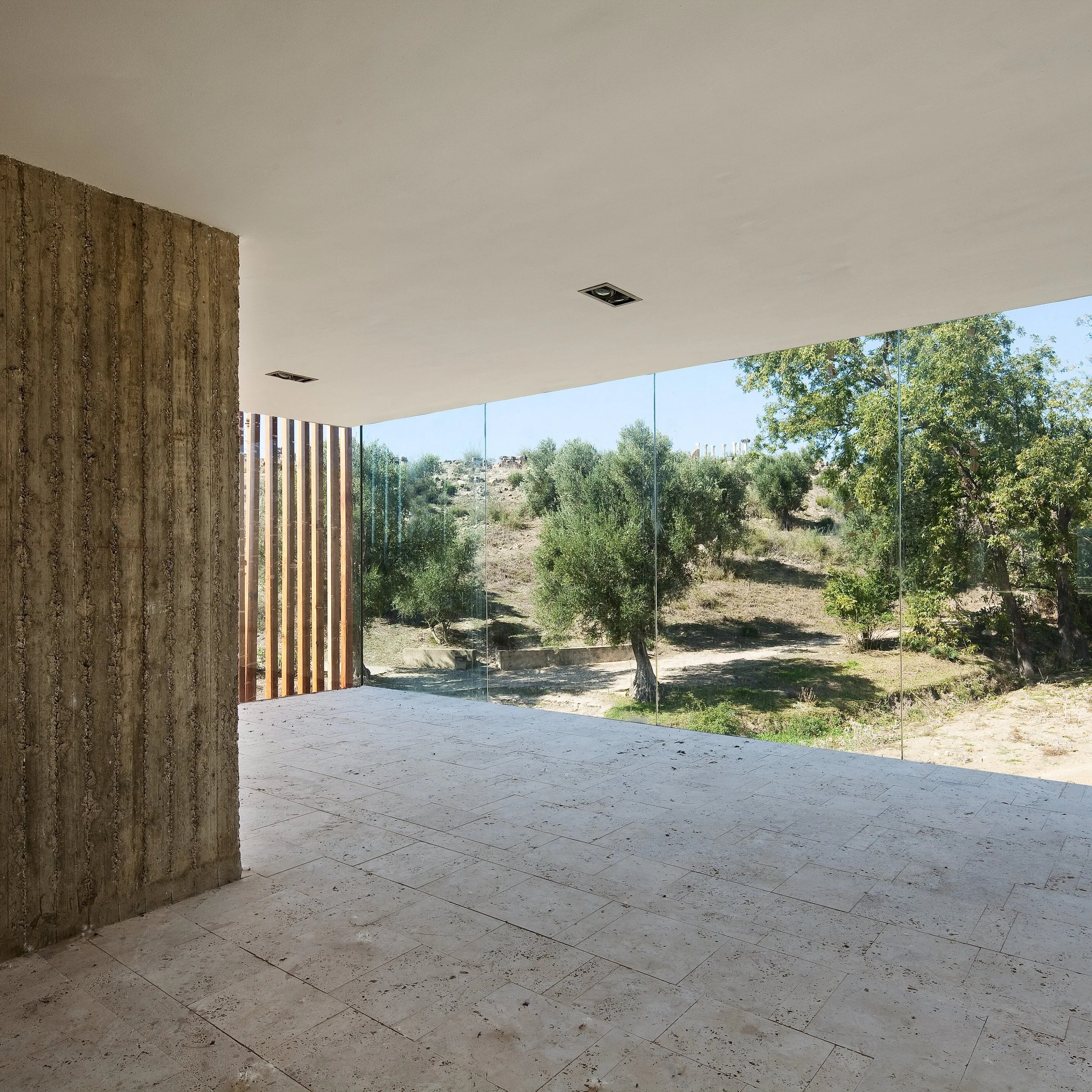 Set along the edge of Morocco&rsquo;s most iconic Roman site, this museum subtly blends into the landscape, echoing the linear geometry of the ruins it protects. Designed as a narrow, 200-meter-long footprint, the building is a rhythmic sequence of w