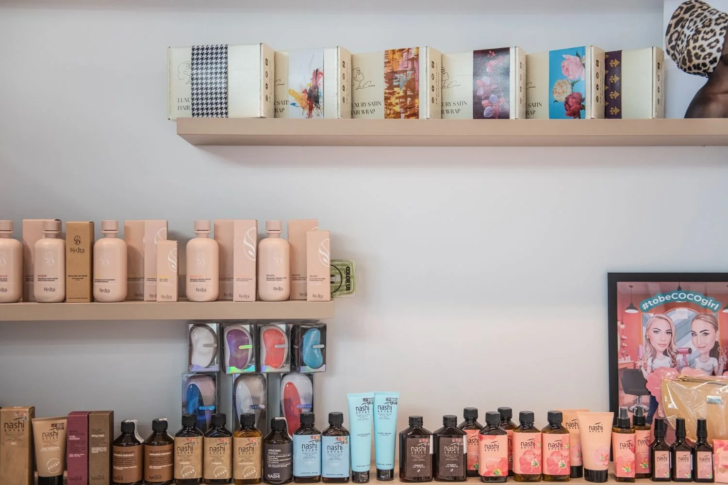 Display of assorted skincare and cosmetic products on shelves, including bottles, jars, and boxed items.