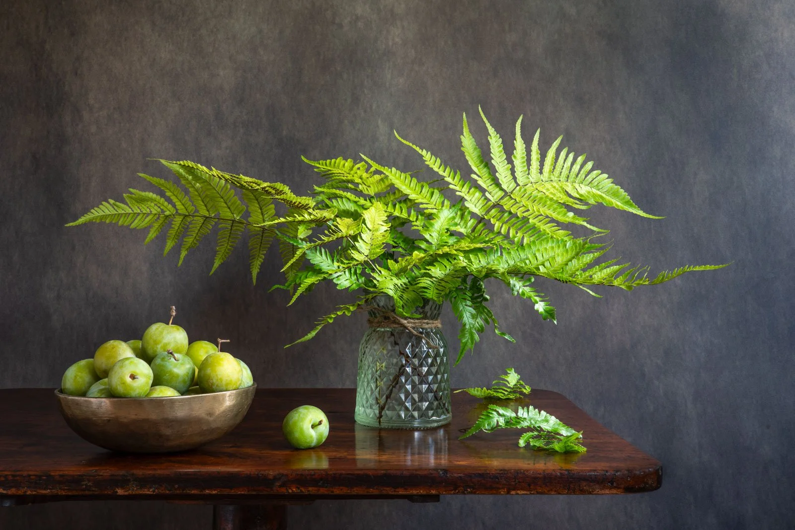 Still life of ferns and greengages, photographed by Wendy Akers