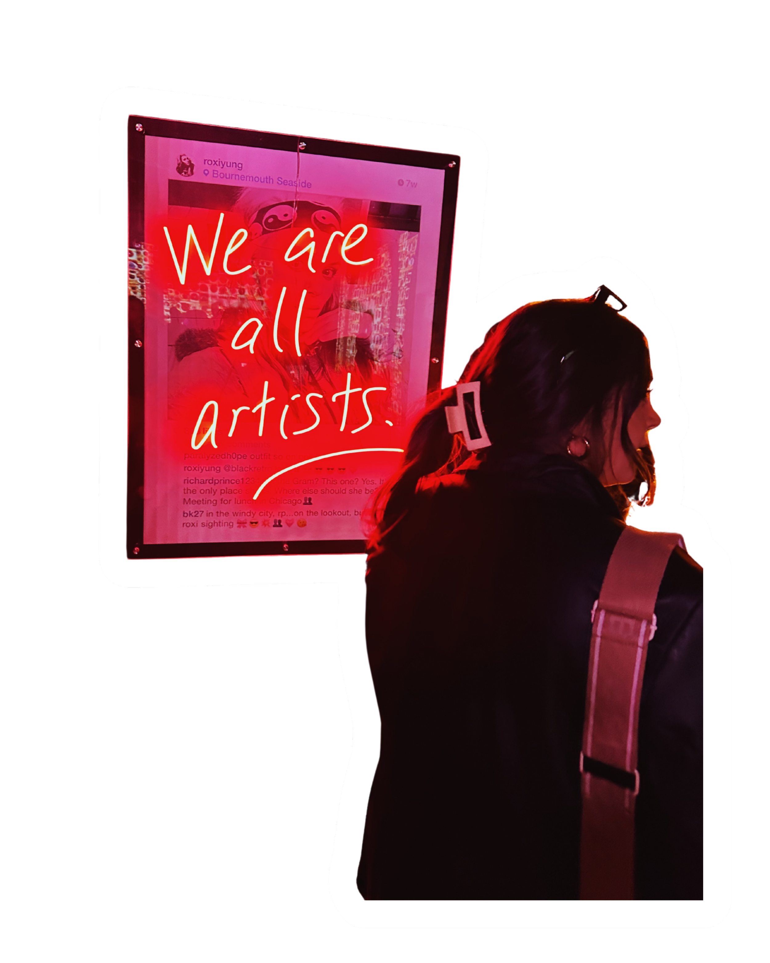 A person wearing headphones standing in front of a digital screen with a red neon sign that says 'We are all artists' on it.