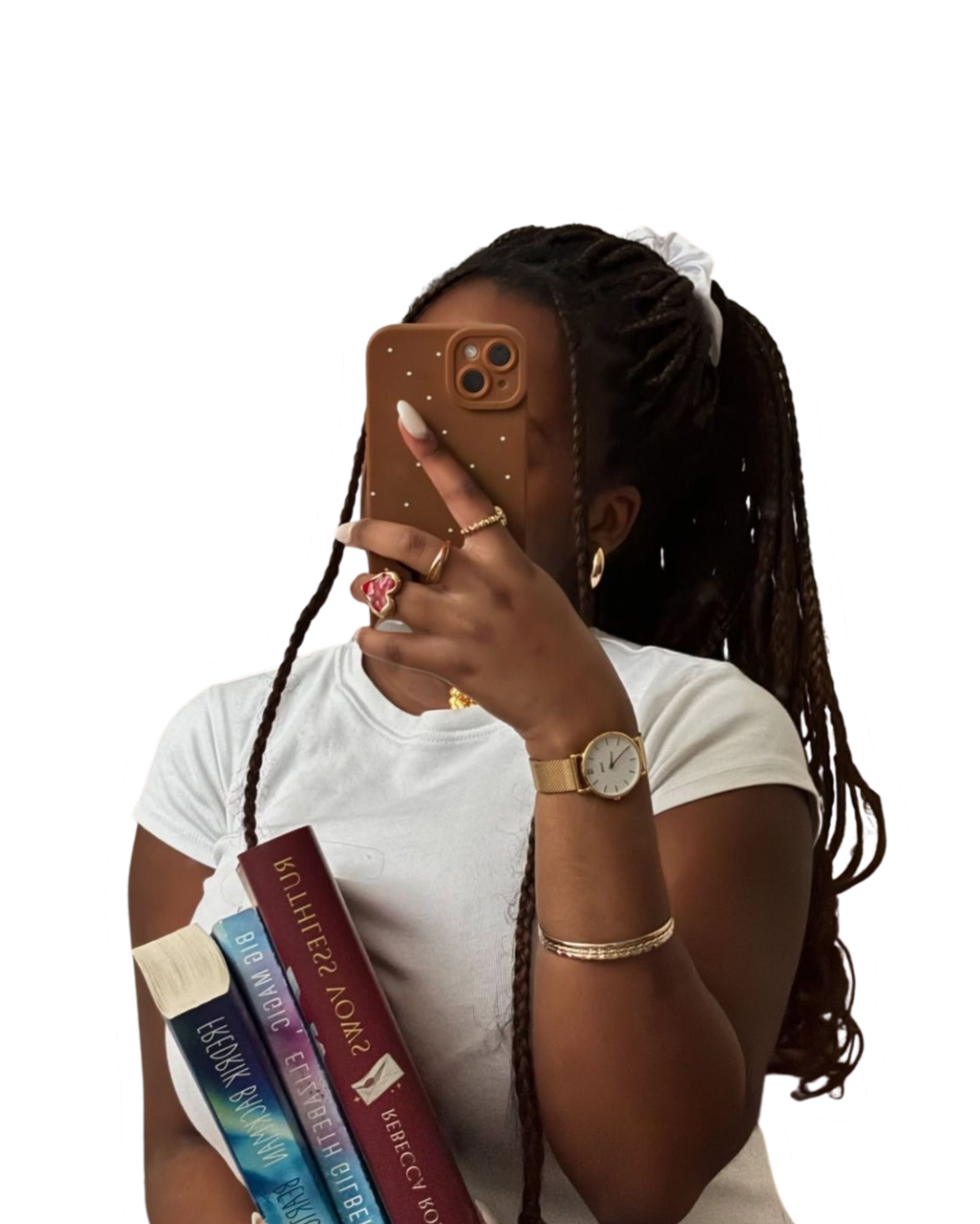 A woman with long dark dreadlocks holding a stack of books and taking a mirror selfie with her phone, which has a brown starry case. She is wearing a white shirt, gold jewelry, and a gold watch.